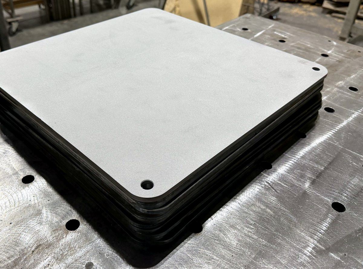 Finished, sandblasted pizza steels stacked and ready to ship